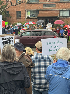 Long shot of Shadyside Hands Off Rally featuring signs thanking Cory Booker