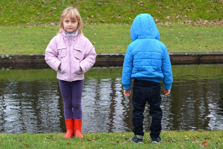 Girl looking forward. Boy looking backward. Opposites.